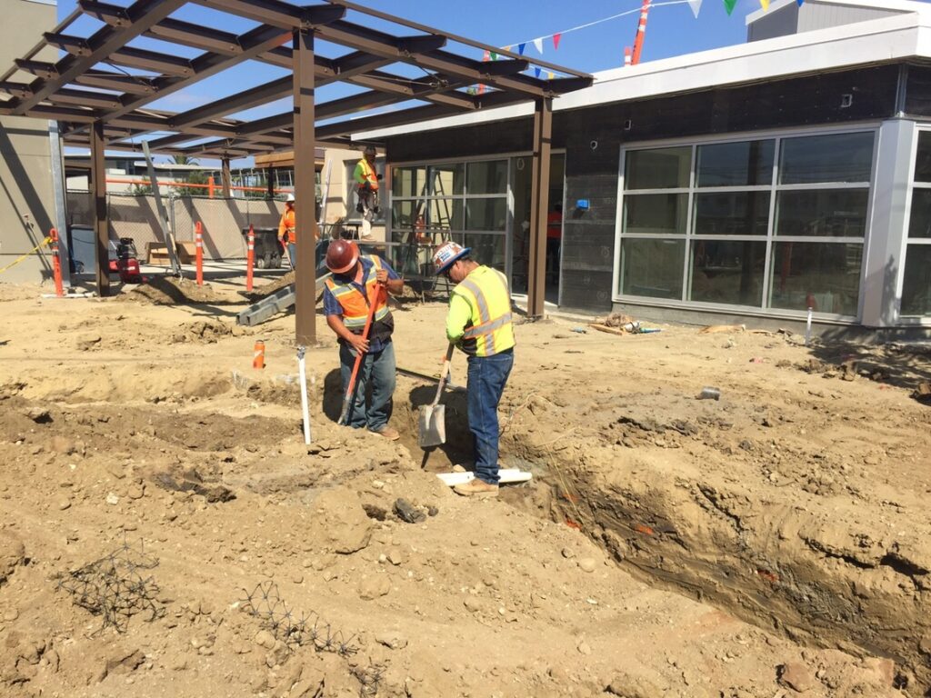 Two men digging the ground